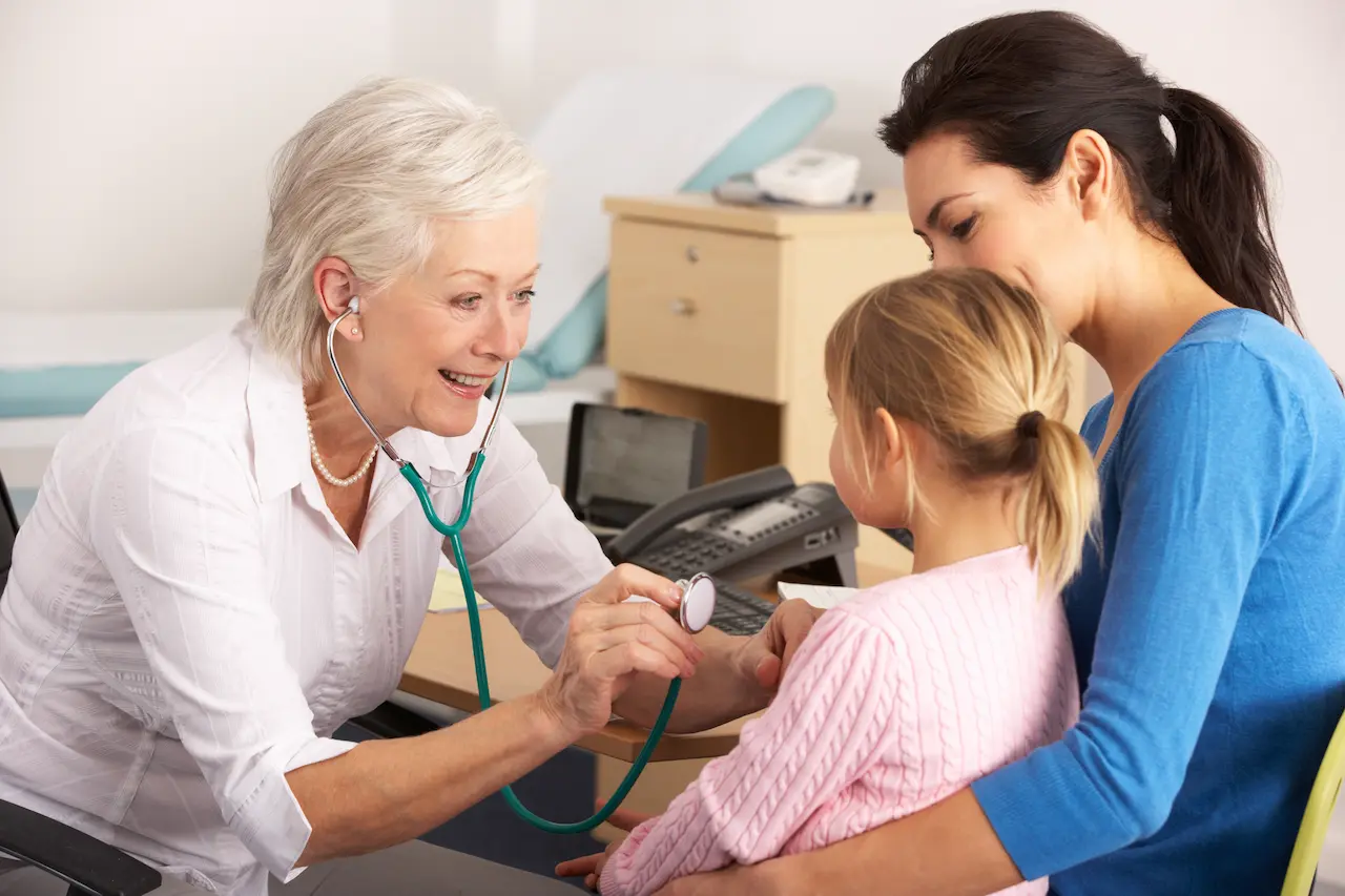 Doctor using a stethoscope on a child